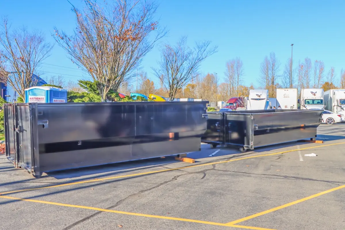 Professional dumpster rental service with roll-off container on residential driveway in La Habra